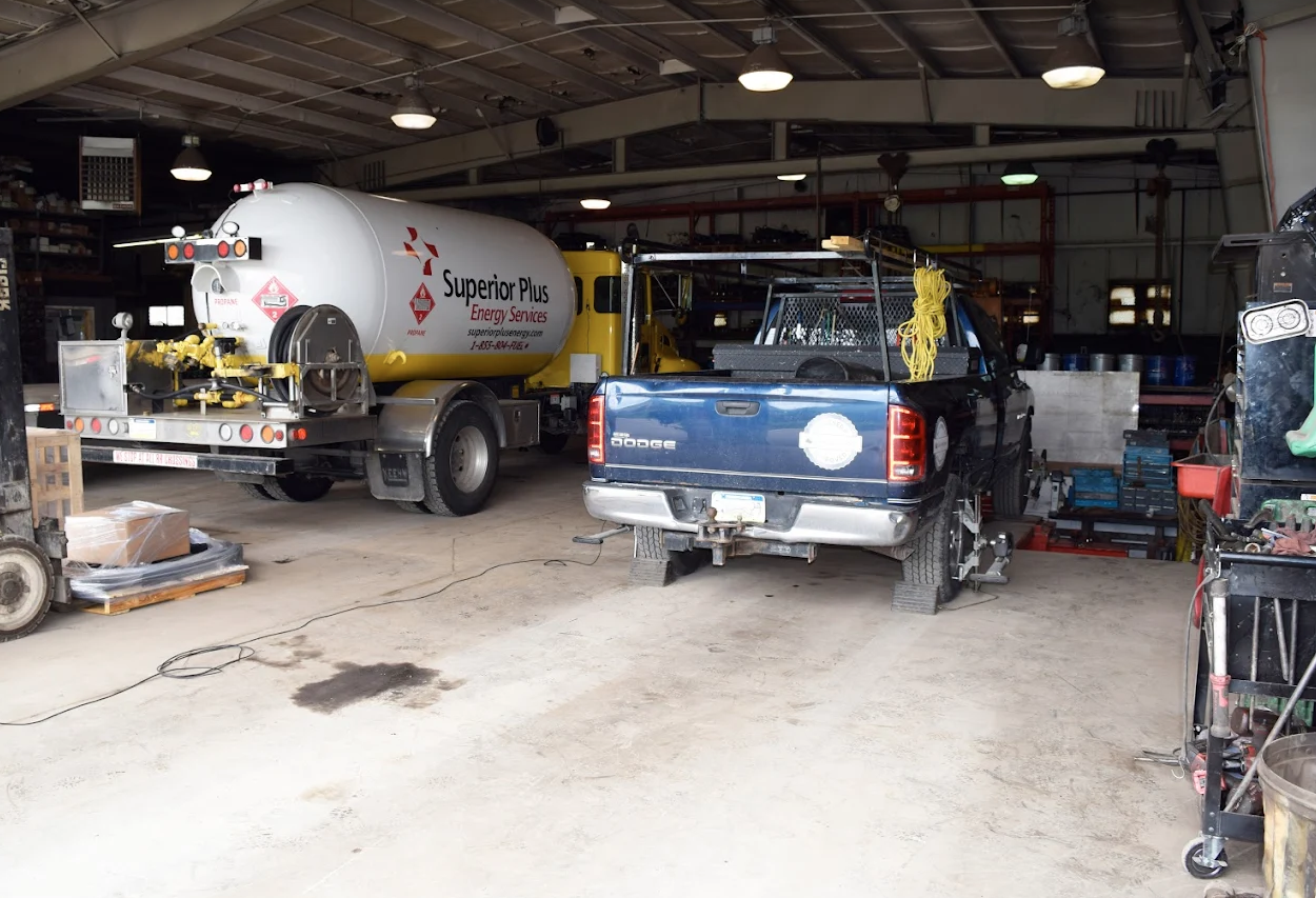 superior gas truck and blue work truck getting service and repairs at shop